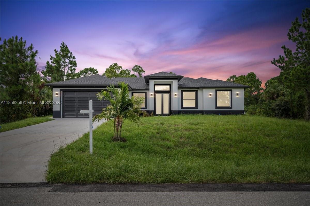 Just completed 2025 new construction on ½ acre in Lehigh Acres—no HOA and move-in ready! This 3 bed + den, 2 bath home features a bright open floor plan with impact-resistant windows and doors, full porcelain tile throughout, and stainless steel appliances. The modern kitchen offers a large island, soft-close cabinetry, and overlooks the spacious living and dining areas filled with natural light. Split-bedroom layout provides privacy, with a luxurious primary suite featuring a walk-in closet and double vanity bath. Also includes water softener, alarm system, and oversized 2-car garage. Enjoy a large lot with plenty of space for a pool, RV, or boat. High-end finishes, quality construction, and room to grow—why wait to build?