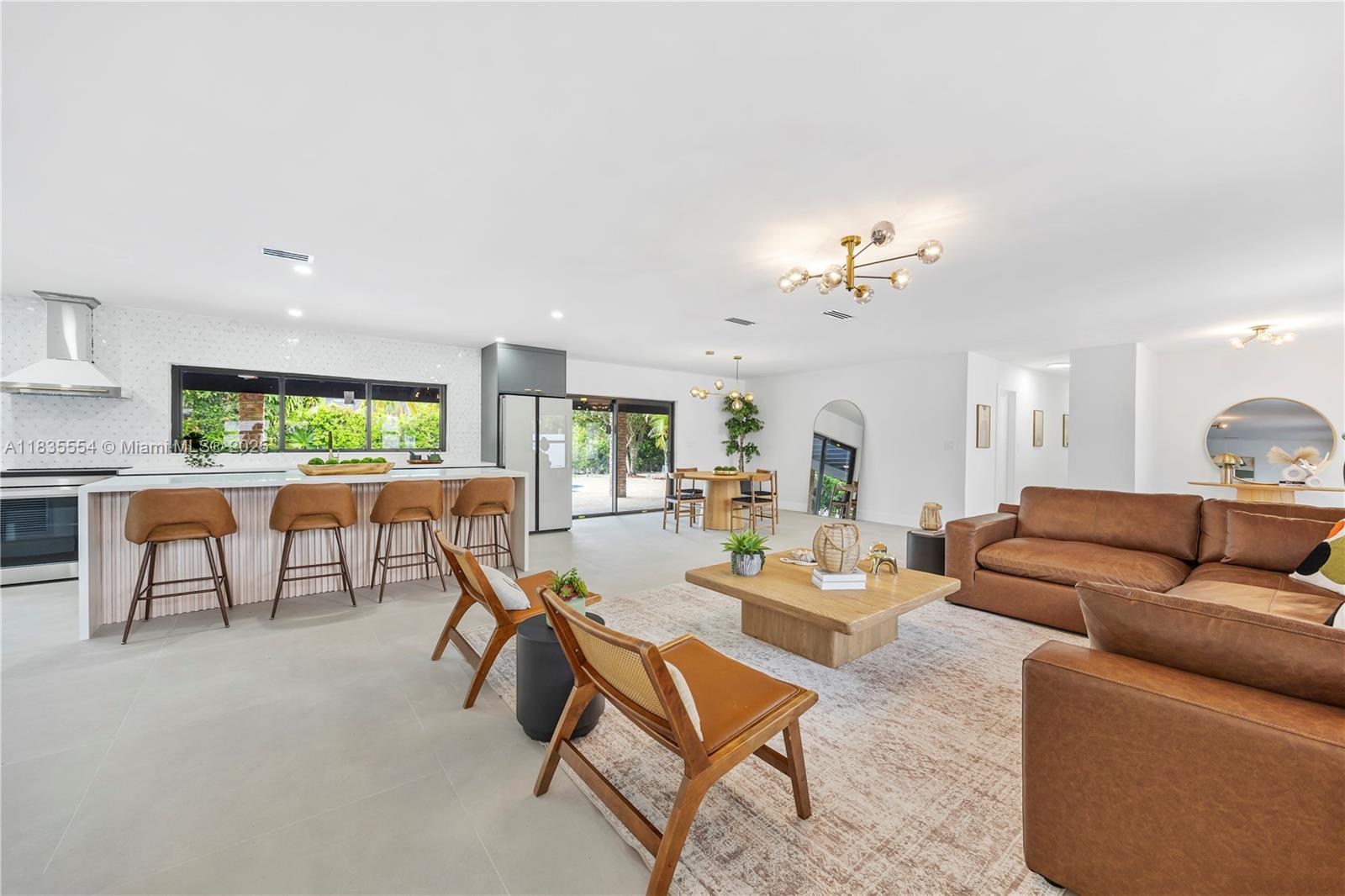 Stunning home in a prime Kendall location! Featuring a modern kitchen and stylish bathrooms, this 4-bedroom gem offers a resurfaced pool with new pump, metal roof, and impact windows/doors for peace of mind. Spacious 15,000+ sq ft lot with room for a boat, lush landscaping, and fruit trees. Enjoy indoor-outdoor living with a large covered patio and circular driveway. Located near top-rated schools, shopping, and parks. A perfect blend of style, comfort, and functionality move-in ready!