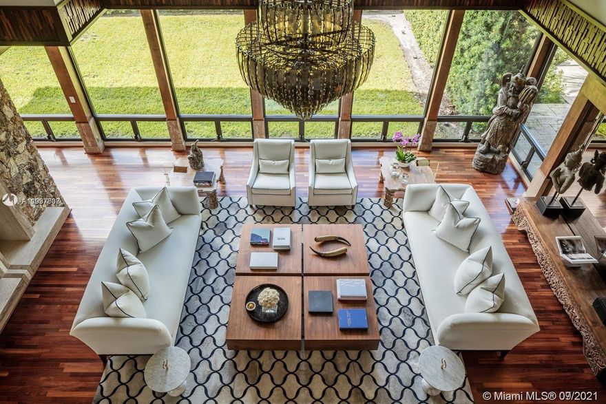 Step Inside With Me! This truly unique residence is where Aspen meets Miami. Influenced by Frank Lloyd Wright, the design inspires nature's tranquility w indoor gardens, koi pond & a grand salon w 30' ceilings. Previously owned by a famous artist, this 6 Bed|9 Bath residence has been renovated & impeccably finished w no expense spared. The primary suite feats dual calacatta-clad baths,closets by Ornare,gym & spa w both sauna & steam rooms. Geared toward entertaining, the home feats a gorgeous chef's kitchen,climate-controlled wine cellar, fireplace & dual-sided bar for indoor & outdoor service alike,& a 10' deep pool. Sitting on 94' of water w direct access to open bay & situated in one of only a handful of truly private communities in all Miami, this property can be yours to call home