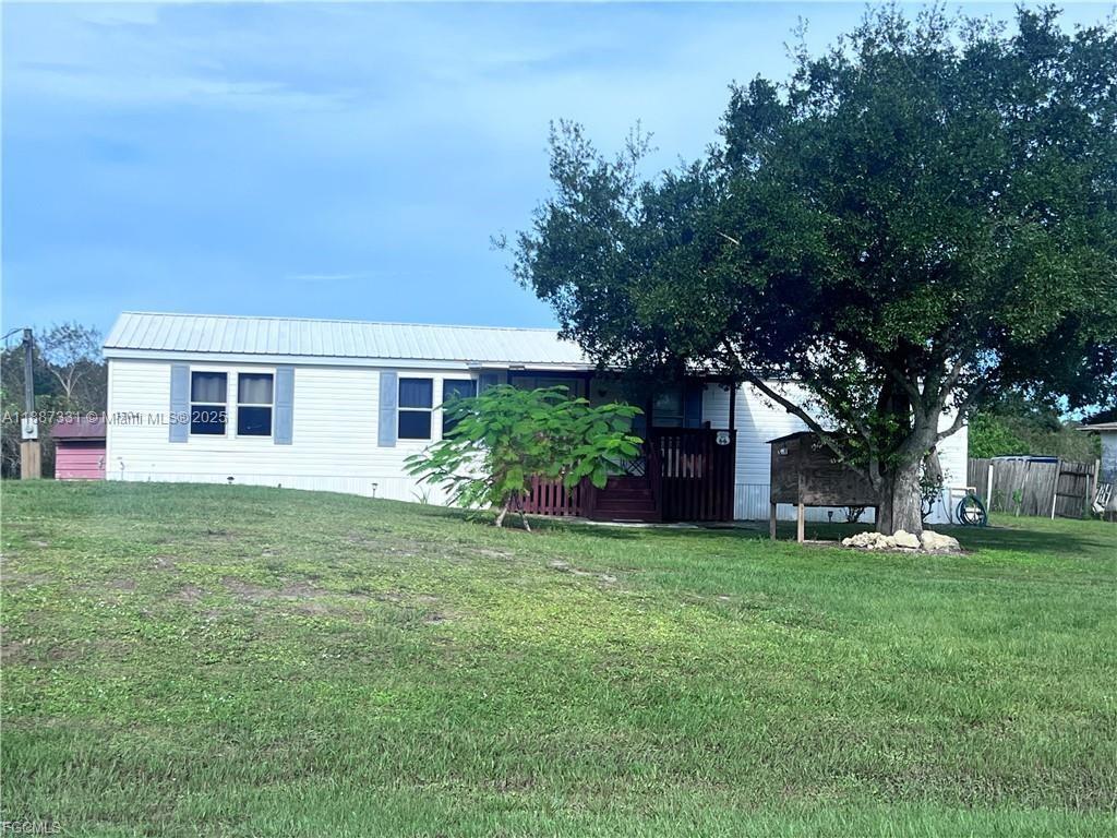 Escape the city and embrace the tranquility of rural life with this charming 3/2 manufactured home located in the heart of LaBelle! Built in 1998, and 1,440 sq. ft. this solid home features a durable metal roof, spacious interior, and sits on half an acre perfect for outdoor enthusiasts, gardeners, or anyone looking for room to spread out. This home is ideal for those who crave peace, privacy, and plenty of yard space. Whether you're dreaming of raising chickens, planting fruit trees, or simply enjoying the stars at night without city lights this home makes it possible.