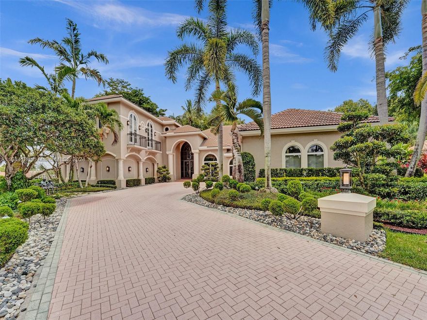 Discover the exclusive residence in the Laurels at Weston Hills CC, showcasing sophistication with golf course and water views. This luxurious home spans 8,303 sq ft on a 25,706 sq ft lot, featuring 5 ensuite BD, 6 BA, 3 half baths, game room loft, gym with sauna, theater room, wine room, and yoga room. The primary suite on first floor includes a vast bathroom, spa, private laundry room, and grand walk-in closet. The renovated kitchen has Miele appliances. 123-inch Sony 4K projector in the theater room. Outside, enjoy a large heated pool with spa, putting green, and basketball court, all surrounded by private landscaping. Upgrades: New roof and impact windows. Unparalleled luxury in a serene cul-de-sac. Full details on features and upgrades are attached.