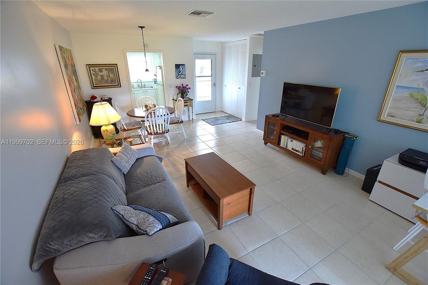 This stunning turnkey unit boasts breathtaking water views with no direct neighbors behind for added privacy. Inside, it shines with updated bathrooms and a newer AC, offering comfort and style. Low-maintenance living covers exterior insurance, water, cable, and internet. Relax in the inviting front seating area, unwind on the spacious screened-in patio with storage, or fire up the grill at the perfect waterfront spot—ideal for entertaining or basking in the sunshine.