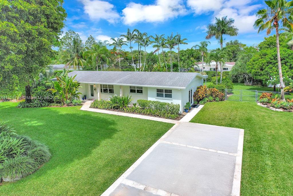 Welcome to this tropical oasis sitting on nearly half an acre in the heart of Palmetto Bay. Imagine unwinding in your backyard paradise, complete with a pristine pool, covered terrace, surrounded by well-manicured landscaping. This expansive lot allows for room to entertain or expand upon the home. Inside, you’ll find an immaculately maintained 3/2 home offers a flexible layout, with an additional room with its own entrance—perfect for an office, playroom, or guests. The updated kitchen features custom cabinetry and newer appliances. There’s plenty of storage with Elfa-organized closets throughout. An extra-wide modern driveway offers ample parking. Don’t miss this gem with great curb appeal, located on a quiet street minutes from Coral Reef Park and A rated schools.