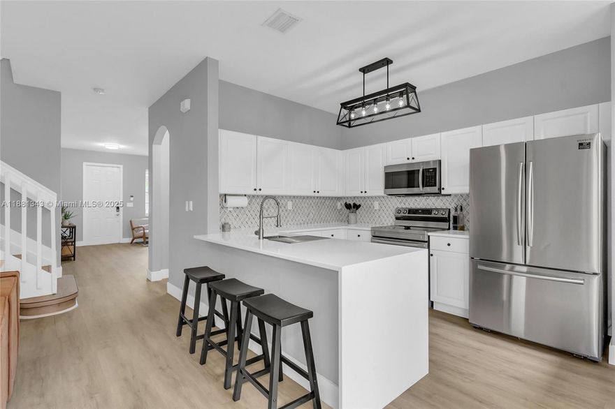 Beautifully remodeled in coveted Tuscany Village! Sunlit first floor showcases new flooring and a remodeled, open-concept kitchen anchoring spacious living/dining—ideal for entertaining. Retreat to a generous primary suite with oversized walk-in closet and spa bath featuring a Roman tub and separate shower. Well-sized secondary bedrooms offer privacy and flexibility (guest/office). Convenient upstairs laundry with full-size W/D. Enjoy a private, fenced patio, tastefully landscaped with artificial turf and pea rock for ultra–low maintenance—plus a 1-car garage. Excellent spot near guest parking. Low HOA $135/mo,  24-hr security, clubhouse, fitness center, two pools, and playground. Minutes to the Turnpike, shopping, dining, and area schools. Impeccably maintained and truly move-in ready!