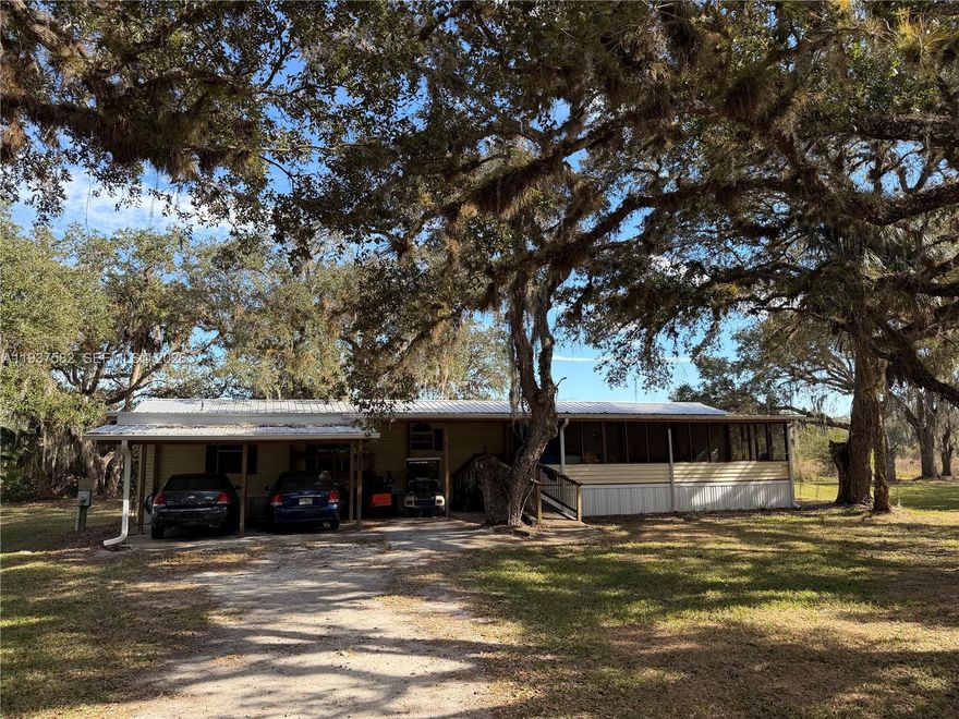 PRICED TO SELL! Beautiful 2.42-acre property surrounded by mature oak trees, offering privacy and a peaceful setting just minutes from the heart of LaBelle. The home features a metal roof (replaced in 2015), along with a covered patio and covered front entrance. Conveniently located near State Road 29 and located on the Glades County border, this property offers easy access to town while maintaining a peaceful rural feel. A rare opportunity to own a spacious parcel at an excellent value. Bring your offers! NO HOA.