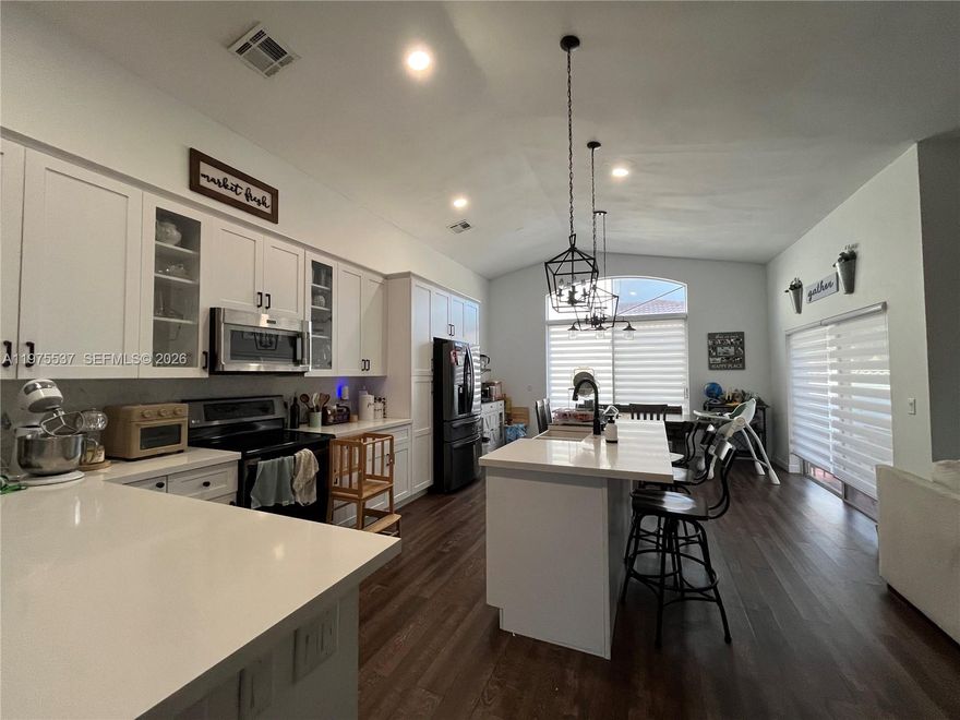 Back on market — buyer canceled during due diligence. No inspection issues.

Seller reviewing offers within 21 days

Beautifully updated 3bed/2bath home on a white-fenced corner lot in the private gated island community of Las Brisas in Silver Lakes. This move-in-ready property features an open floor plan with vaulted ceilings, tile in the bathrooms, and vinyl flooring throughout the living areas and bedrooms. The modern white kitchen offers white quartz countertops, stainless steel appliances (LG fridge negotiable), custom pantry, island with farmhouse sink, and custom lighting. Split-bedroom layout includes a primary suite with two walk-in closets with custom shelving, a spa-like bath with dual sinks, French tub, and custom shower, plus an updated second bathroom. Major systems are updated with a 2016 roof, 2021 A/C, and 2017 water heater, along with tinted windows, hurricane shutters, custom garage cabinets and shelving with attic storage, and a 200-amp manual double-throw transfer switch with exterior generator inlet for a portable generator. Outdoors, enjoy a stable leveled shed, playground with sandbox and swings, mango tree, and canopy for shaded relaxation. Residents have access to community amenities including pool, clubhouse, playground, volleyball court, boat ramp/dock, lake, picnic areas, and jogging paths around the lake.