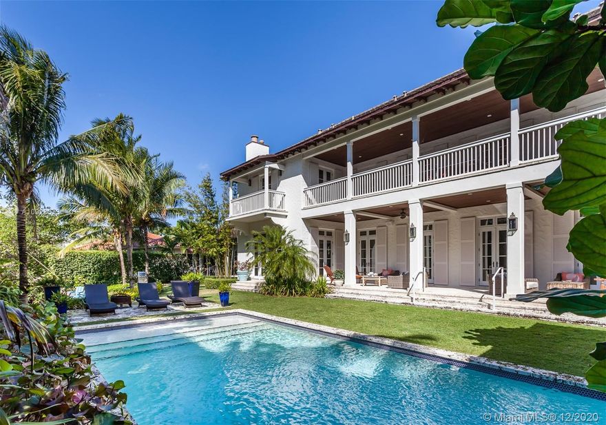 This custom built two-story waterfront home is truly remarkable, with no expense spared and every detail a mark of perfection. Situated on a corner lot,  the French doors lining the back of the home overlook a sparkling pool and beautiful landscaping, and provide exceptional views down the length of the waterway beyond. The home features a gourmet kitchen, formal dining room, and a principal suite with direct water views. Large family rooms are found on both floors, and there also are separate guest quarters and a 2-car garage with space for two lifts.