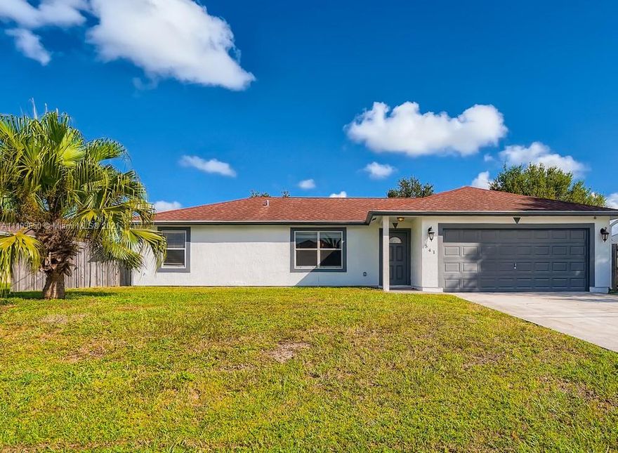 Lovely 3 bedroom, 2 bathroom single-family home in Port Saint Lucie! This perfect starter home or investment opportunity is located on a large lot and offers a spacious layout in a very convenient location. Upon entering this home you will find a spacious living room area leading to the kitchen with plenty of windows allowing for natural light and beautiful neutral paint throughout. In the kitchen, you will find lots of wooden cabinets for storage space. The exterior of this home features a large lot that is fenced-in complete with a spacious patio area and enough room for a pool making this home perfect for outdoor entertaining. This home is conveniently located just minutes from major roadways, shopping, dining, and more!