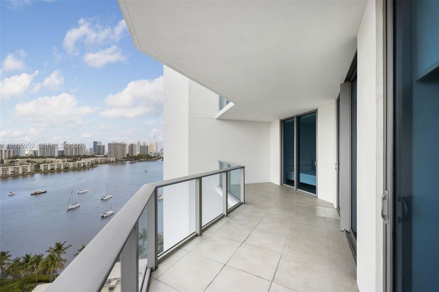 A refined waterfront residence at Marina Palms, offering elevated living with sweeping water views and direct access to a full-service marina and yacht club. Built in 2015 and impeccably maintained, this fully furnished 2-bedroom plus den showcases a desirable split floor plan, soaring ceilings, and expansive windows that fill the interiors with natural light. The versatile den offers flexibility for a third bedroom, office, or private retreat, while the primary suite is thoughtfully designed with a spacious walk-in closet and refined finishes. An open living and dining area extends seamlessly to a private balcony, creating an effortless indoor-outdoor flow. Residents enjoy a curated collection of resort-style amenities, including a state-of-the-art fitness center, Pilates studio, spa, sauna, and a waterfront pool with lounge areas. Additional offerings include a party room, children’s play spaces, concierge, valet, and top-tier security, delivering a lifestyle defined by comfort, convenience, and waterfront sophistication.