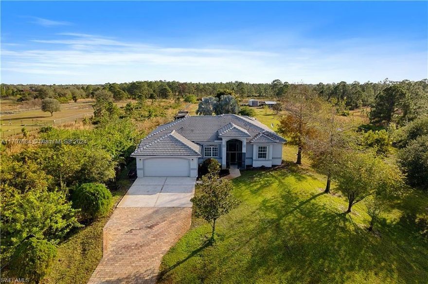 Discover this stunning property nestled on a sprawling 2.35-acre lot with endless possibilities! This meticulously maintained home offerERS 1,725 sq. ft. of living space and a total of 2,127 sq. ft. The elegant interior showcases tile and wood flooring, and a charming tile roof that adds timeless character to the home. Oversized saltwater pool and spa, complete with a pool heater. The expansive lot includes fruit and magnolia trees, and offers a separate independent rear entrance. The fully fenced and cleared property provides privacy and functionality, while the grand paved driveway adds to the curb appeal. This is your chance to own a piece of paradise with room to grow and customize to your needs. Note to Realtors: Please refer to showing remarks for additional details.