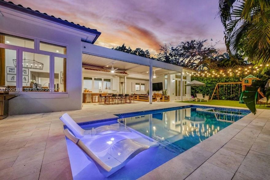 This beautifully updated 4 bedroom, 3.5 bathroom Coral Gables home delivers on every level. Thoughtfully expanded in 2019, the gracious layout features vaulted ceilings in the kitchen that carry seamlessly into the family room, creating an open and inviting living experience. The lifestyle flows naturally outdoors through impressive, oversized sliding glass panels, where nearly 600 square feet of covered patio, a retractable screened pergola, heated pool and spa, outdoor kitchen, cabana bath, and a polished blend of pavers and turf make it clear this home was built for living well inside and out.
The primary suite enjoys its own sense of privacy, complete with vaulted ceilings and a beautifully appointed bathroom. The updated kitchen is outfitted with Thermador appliances, bathrooms have all been renovated, and one additional bedroom features its own ensuite bath. A newer roof, impact windows and doors, a dedicated laundry room, wet bar, and a generous two car garage of over 500 sq ft round out a home where every detail has been considered.
Set on a quiet, tree lined dead end street and just a stone's throw from the Granada Golf Course and minutes from shops, restaurants, and energy of Downtown Coral Gables.