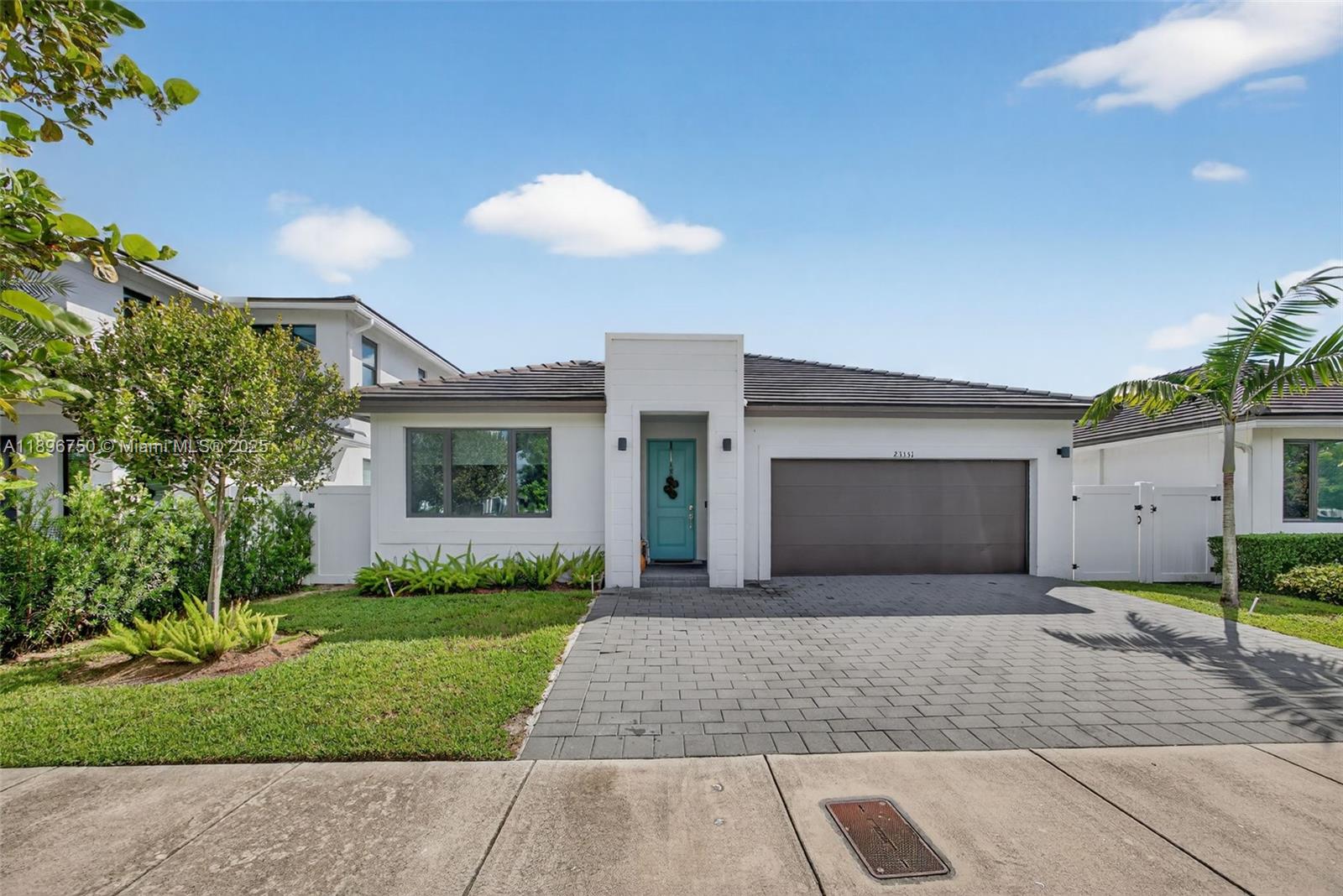 Built in 2021, this beautifully maintained residence showcases modern design and pride of ownership. Features include impact windows and doors, an open-concept kitchen, a backyard terrace perfect for entertaining, and a two-car garage with a driveway accommodating up to three cars. The home offers a legal 4-bedroom, 3-bath layout with builder-permitted add-ons (documents available). The primary suite features his-and-hers closets and a spacious bathroom with dual sinks, and an additional closet inside the bathroom. A home designed for comfort, style, and everyday living!