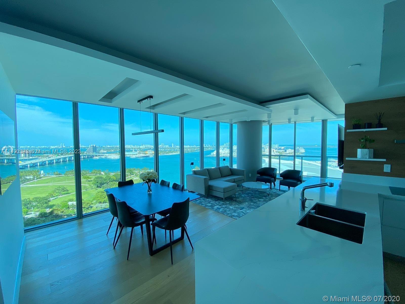 -This tastefully designed unit is located in a prime location in Miami, overlooking Biscayne Bay and the Miami Arena area, this unit meets all expectations related to views. This 2 bedroom/2.5 bathroom condo offers warm hardwood floors, an open floor plan with private bathrooms in both rooms, an upgraded kitchen, electric shutters, special lighting design, and much more. Marinablue is an iconic skyscraper in Miami known for its unique amenities, including sunrise and sunset pools, 5-hole putting green, volleyball court, spa, on-site restaurants, convenient shopping, and more. Walk to the Miami Arena for special concerts or basketball games. unit is one of a kind.