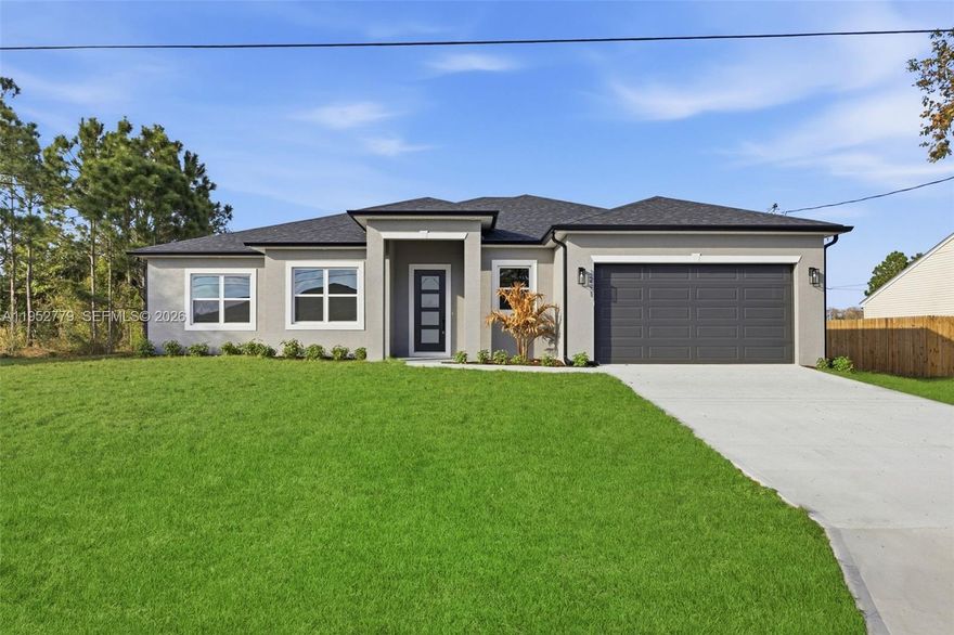 Experience modern luxury in this new build with completion date of 3/2026, showcasing premium finishes and thoughtful craftsmanship throughout. This home features stunning quartz countertops, 10-ft ceilings, and vaulted ceilings that enhance the bright, open layout. The kitchen is equipped with 42'' upper cabinets and quality details designed for both function and style. Interior upgrades include 8-ft interior doors, 8-ft garage doors, durable LVP flooring, and bathrooms finished with ceramic tile to the ceiling for a clean, elevated look. Enjoy added peace of mind with a front impact door and a whole-home water filtration system. The home offers a full-service laundry room and a beautifully designed covered lanai, perfect for relaxing or entertaining year-round. Electric car hookup in garage. This brand-new residence blends comfort, elegance, and modern living—move-in ready and built to impress. 2-10 Warranty Included.