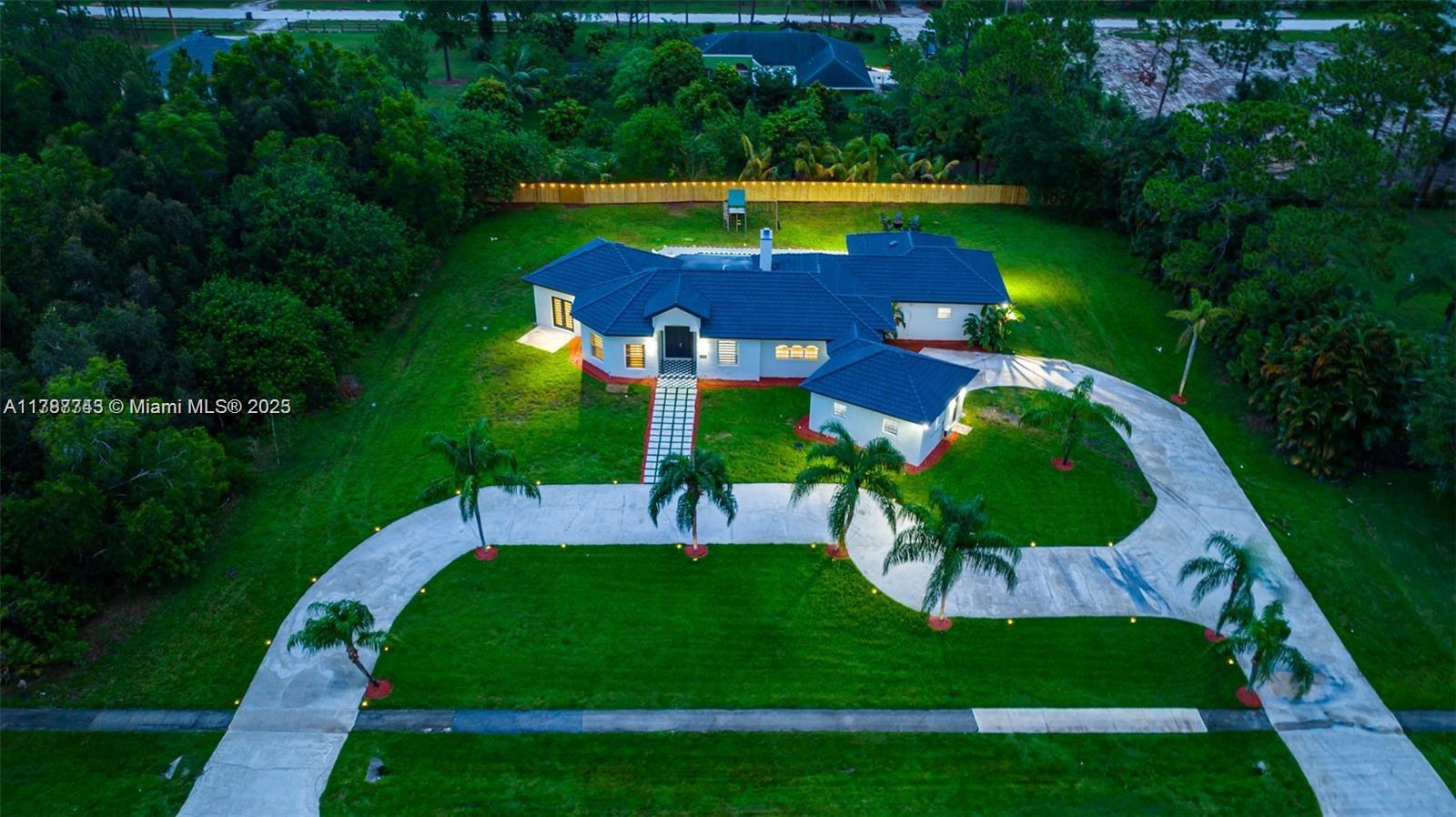Experience resort-style living in this custom Mediterranean estate featuring 6 bedrooms and 4 bathrooms across 3,259 sq ft. Set on 1.19 acres, the home boasts an open-concept layout with a gourmet kitchen, tall ceilings, and elegant stone columns. The entryway leads directly to an 18x36 in-ground pool, perfect for entertaining or relaxing. Additional amenities include walk-in closets, a game room, and a spacious backyard. Located in the serene Loxahatchee neighborhood, this property offers both luxury and tranquility.