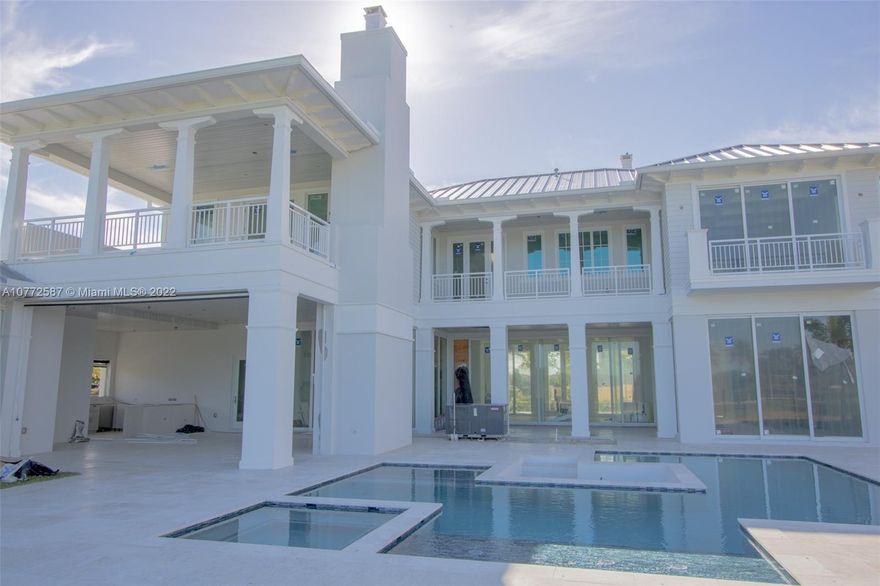 Spectacular builder's own custom estate ready in first quarter 2022 in The Enclave at Coral Ridge Country Club, an exclusive 24 hour guard gated community with only 36 residences.  Situated on the fourth largest lot on the desirable east side and overlooking the 12th tee of soon to be completed new course.  Features include gourmet kitchen, theater lounge, Crestron home automation, volume ceilings, elevator, wine cellar, 2 laundry rooms, generator, Hardie Boys exterior trim and metal roof.  2,292 sq ft of balconies plus 1,043 sq ft of space in the four car garage.  Oversized 20,876 square foot lot, separate guest house, resort style pool, outdoor mosquito and hurricane roller screens, bocce ball area, fire pit and expansive outdoor living spaces.