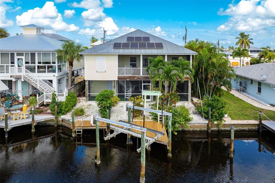 CALL MATLACHA HOME OR USE AS A VACATION RENTAL WITH NO WATER-INTRUSION WORRIES—CURRENTLY INCOME-PRODUCING This elevated 2-bedroom, 2-bath waterfront retreat offers island living at its best with hurricane-impact windows, an open kitchen-to-great-room layout, and stunning water views from nearly every room. Both bedrooms are spacious, and a flex space off the great room adds room for guests or a home office. Enjoy morning coffee and wildlife watching from the screened lanai, plus ground-level storage, a second patio, and a newer dock for boating. With minimal Ian damage and no known water intrusion, this is the best-priced elevated home in Matlacha and a move-in-ready paradise.