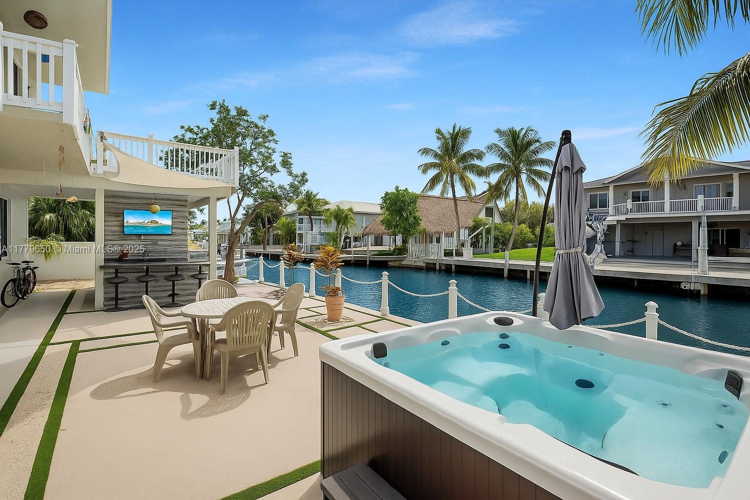 Purchased in 2022 and completely rebuilt with over $350K in renovations! COMPLETE TRANSFORMATION for this Waterfront CBS home in Key Largo, FL! Once equipped with wall-unit ACs and outdated features, it’s now a modern, elevated gem. Taken to the studs—new walls, plumbing, electrical, impact windows/doors, and new central AC. Raised 1.5 ft—no flooding! Upstairs: 2-bed, 2-bath main home w/ dual master suites + new terrace/sun deck. Downstairs: separate 1-bed, 1-bath w/ full kitchen, private entry—ideal in-law quarters or rental (Zoned 28-day rentals). New kitchens, baths, outdoor kitchen, gazebo, jacuzzi, 75' dock, on premises PRIVATE boat ramp, and plenty of space for a pool. The front features a circular driveway, side parking, and across a tranquil preserve—no front neighbors! A MUST SEE!
