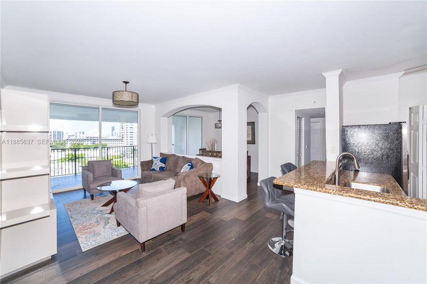 Immaculate and spacious corner penthouse unit, boasting 3 bedrooms & 2 bathrooms in one of the largest floorplans available. This beautifully renovated apt features soaring high ceilings, elegant tile flooring, and a freshly remodeled master bath with premium finishes. The upgraded closets offer abundant storage, while the tasteful furnishings make this unit truly move-in ready. Enjoy breathtaking views of the canal, ocean, and Intracoastal, along with the unique charm of a fixed pedestrian bridge, all from your private, light-filled sanctuary. Located in a pet-friendly Mediterranean Style building, with luxury resort-style amenities. Covered, assigned parking space. Prime location, just steps from the beach, fine dining, shopping, entertainment, top-rated A schools & more. Do not miss it!