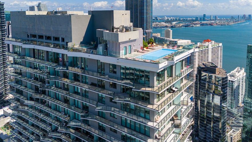 Stunning 2 Story Brickell Penthouse offering YOUR PRIVATE ROOFTOP TERRACE WITH PLUNGE POOL and over 1,100 SF of additional outdoor living space. This sophisticated two-story corner residence is fully furnished and designed for turnkey living. Featuring 4 bedrooms and 3.5 bathrooms, the home showcases refined finishes, curated artwork, and a well-designed layout. Floor-to-ceiling windows and a wraparound balcony capture breathtaking ocean and city views. A custom wood-frame spiral staircase leads to the expansive rooftop terrace, perfect for entertaining, complete with Italian porcelain tile, electric grill, outdoor refrigerator, and private plunge pool.  DUA Residences offers the perfect balance of private convenience and 5 star resort style amenities. Exceptional privacy, design, and iconic Brickell views.