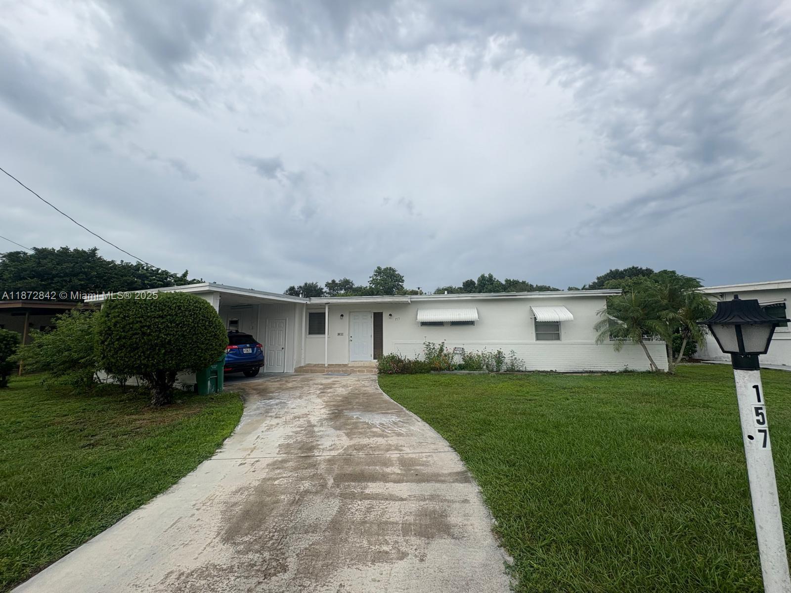River Park, Port St. Lucie! Welcome to this cozy and charming 3-bedroom, 2-bathroom home located in the highly desirable River Park subdivision on Main Street. This well-maintained, move-in ready property features a brand-new roof installed in 2024 with 10-years warranty. NO HOA, the home can be rented Short-Term or Long-Term without restrictions. The 0.26-acre vacant lot mature fruit trees and offers plenty of space for gardening, boat/RV, a pool, or even future expansion. Nestled just minutes from the scenic River Park Marina, enjoy easy access to beaches, fishing, kayaking, and peaceful waterside trails, making it ideal for Airbnb, Vrbo, or seasonal rentals. Excellent LOCATION with quick access for both locals and tourists. Schedule your showing today and secure this gem!!