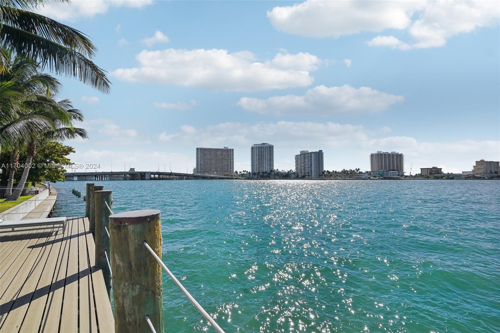 Extra spacious and light filled ground floor unit available in waterfront condo in Normandy Isle. Updated kitchen and bathroom, and tile flooring. The complex features a new deck with 180 degree views right on the bay.