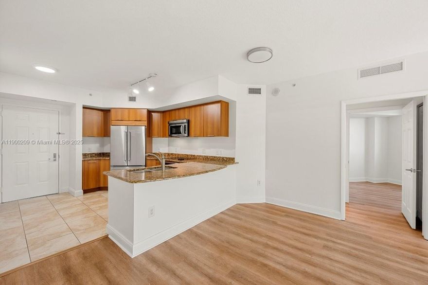 Magnificent and impeccable 2-bedroom, 2-bath condo offering a bright, open layout. Maintenance includes internet, cable TV, water, and two assigned garage spaces. Features include stainless steel appliances, granite counters, impact glass, European cabinetry, marble shower, soaking tub, and smart key fob entry. Enjoy an elegant lobby, resort-style tropical pool and jacuzzi, 24-hour manned security, high-tech security system, fitness center, dry sauna, and more.