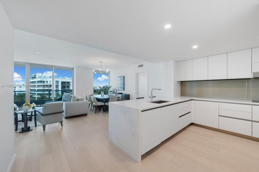 Experience the pinnacle of island living in this expansive 1,800+ sq. ft. residence at La Baia North, an exclusive waterfront enclave. This meticulously designed 2-bedroom + den, 2.5-bathroom home offers a seamless indoor-outdoor flow, curated by New York’s renowned Durukan Design, perfectly capturing the essence of Miami’s sophisticated coastal lifestyle. This residence is a masterclass in modern design, featuring wide-plank European flooring and a chef’s kitchen anchored by custom Snaidero cabinetry, quartz countertops, and a premium Miele appliances. Retreat to the lavish primary suite, a spa-like haven clad in marble with rainfall shower. For ultimate comfort, the home includes custom motorized privacy and blackout shades and premium walk-in closets. Residents enjoy an unparalleled lifestyle with 24/7 concierge service, two covered parking spaces, and a spectacular 10,000 sq. ft. rooftop deck offering a pool, jacuzzi, and 360-degree panoramic views of the Atlantic Ocean and Miami skyline. For the nautical enthusiast, a private residents-only dock provides direct water access, with boat slips available for purchase.