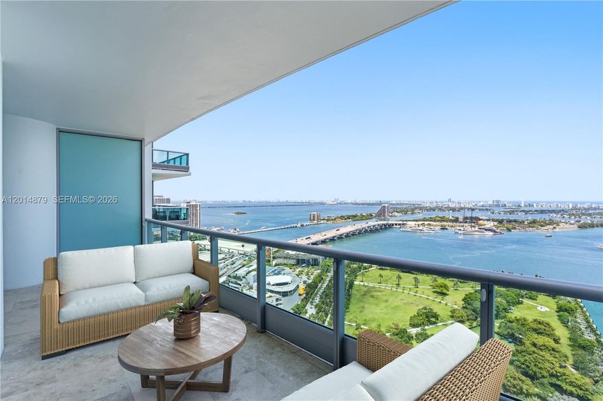 Experience one of the best flow-through floor plans at 900 Biscayne Bay, offering breathtaking direct Biscayne Bay views and nearly 500 SF of terrace space to enjoy both sunrises and sunsets. This highly flexible residence adapts to your lifestyle, functioning as either a 3-bedroom, 3-bathroom home or a spacious 2-bedroom plus den with 3 full baths. Arrive through a private elevator foyer into interiors finished with polished travertine floors, custom shades, and fully built-out high-end closets throughout. The open kitchen features modern waterfall granite countertops and a 55-bottle wine display. All bathrooms have been beautifully renovated with sleek contemporary fixtures and refined finishes. Located in one of Downtown Miami’s most coveted and impeccably managed luxury towers, residents enjoy elevated resort-style amenities including lap and swimming pools, spa, state-of-the-art fitness center, theater, kids’ room, and 24-hour security and valet service. Positioned in the heart of Miami’s transformation into a global destination, you are moments from Miami Worldcenter, museums, the Adrienne Arsht Performing Arts District, dining, entertainment, and more.