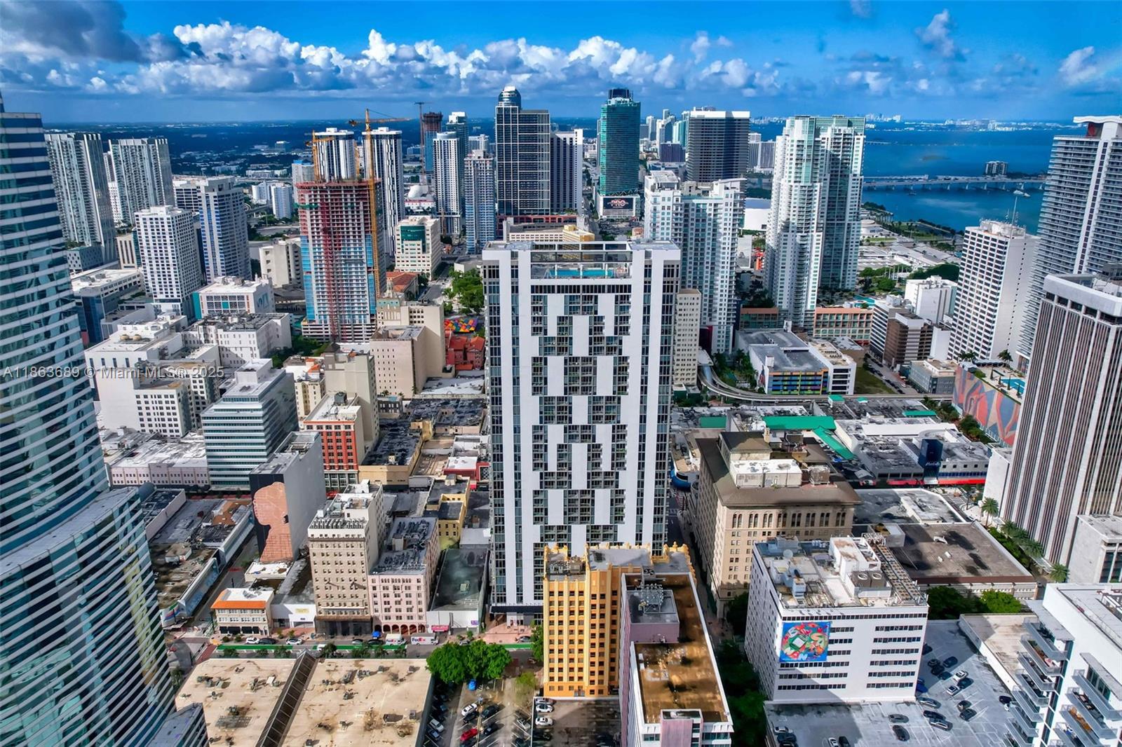 Stunning corner unit with water views of Biscayne Bay and Downtown Miami skyline, all from the comfort of your new loft! This condo features a two bedroom unit with two full baths for a total area of 1,131 SF. The unit comes with beautiful polished concrete floors throughout . This unit features 10-foot high ceilings, expansive floor-to-ceiling glass windows, and custom shades, providing abundant natural light and a seamless connection to the vibrant cityscape. The Italian-inspired kitchen boasts sleek cabinetry, stainless steel appliances, and an open dining-living area perfect for entertaining. Centro Miami offers an array of premium amenities for residents. As for investment minimum rental is 30 days for short term rentals. Walking distance to corporate offices, hotels and restaurants.