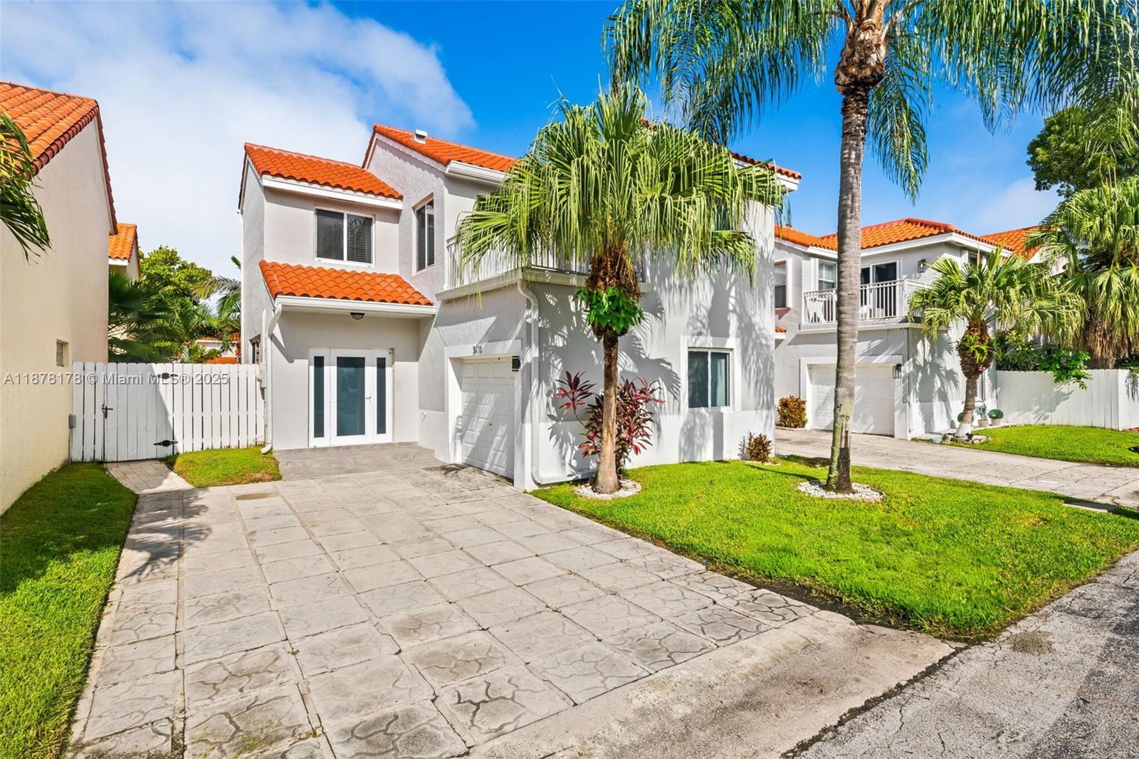 Incredible value in the highly sought-after neighborhood of Emerald Hills! This beautifully updated 3-bedroom, 2.5-bath home features impact windows and doors throughout and a 2021 Tile Roof. Modern open kitchen with quartz countertops, wood cabinetry, and a spacious layout that includes a formal dining room and large living area. The first-floor half bath adds convenience, while upstairs offers generous bedrooms, including a large primary suite with high ceilings, ample closet space, and access to an open balcony. Garage currently used as 4th bedroom. Travertine stone backyard space. The community offers a low HOA fee covering internet, cable, security, landscaping, a large pool, playground, and more.