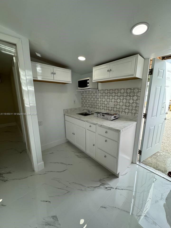 Efficiency unit available for rent. This unit features a small kitchenette, a separate bedroom, a living room area, and a newly renovated bathroom with a shower. Rent includes water, electricity, and internet, and two parking spaces are provided. First month's rent and security deposit required.