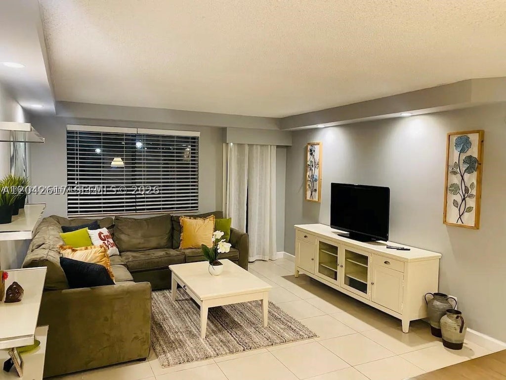 Photo of 301 Golden Isles Dr #109, Hallandale Beach, FL 33009 (MLS # A12042617)