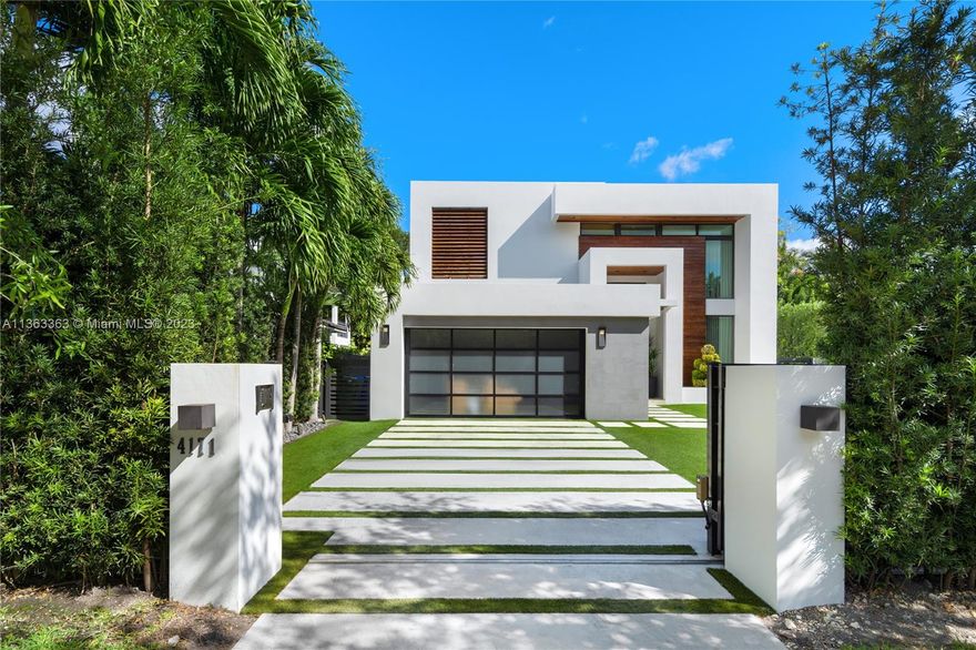 A modern beauty with spectacular finishes. Positioned in prime South Grove, this 2-story home is move-in ready with the sleek splendor you have been looking for in a Miami home. 5 total bedrooms, 4 upstairs and 1 downstairs, all en-suite with 2 guest bedrooms sharing a bathroom. Gorgeous porcelain wood-like floors throughout the entire home. Curated kitchen and walk-in wine cooler (200+bottles) with functionality and aesthetics in mind. Floor to ceiling windows allow the natural light to shine in. Covered outdoor living space with summer kitchen that overlooks the sparkling heated swimming pool with saltwater filter. Low-maintenance yard with artificial turf and native trees/plants with irrigation system. Gated and high-hedge for superior privacy. 2-car garage. Not in a Flood Zone!