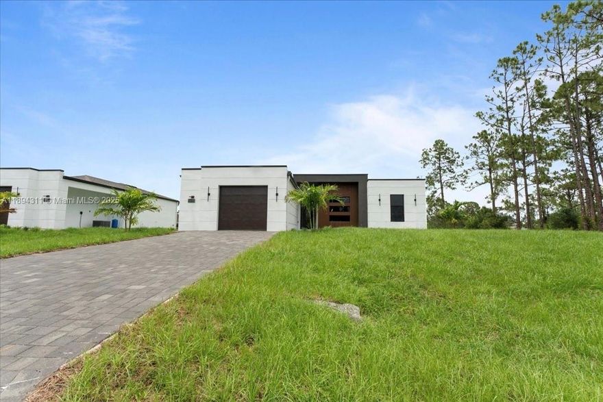 SELLER OFFERING BUYER CONCESSIONS. Don’t miss this move-in-ready home with builder’s warranty included. Modern new construction in Lehigh Acres! This 3-bedroom, 2-bath home offers 1,292 sq ft of living space with an open floor plan, 10-ft ceilings, and stylish finishes throughout. Built with impact windows and doors, porcelain tile flooring, and Calacatta quartz countertops with a waterfall island. Bathrooms feature LED mirrors, floating vanities, and frameless glass showers. Exterior includes paved driveway, epoxy garage floor, and irrigation system.