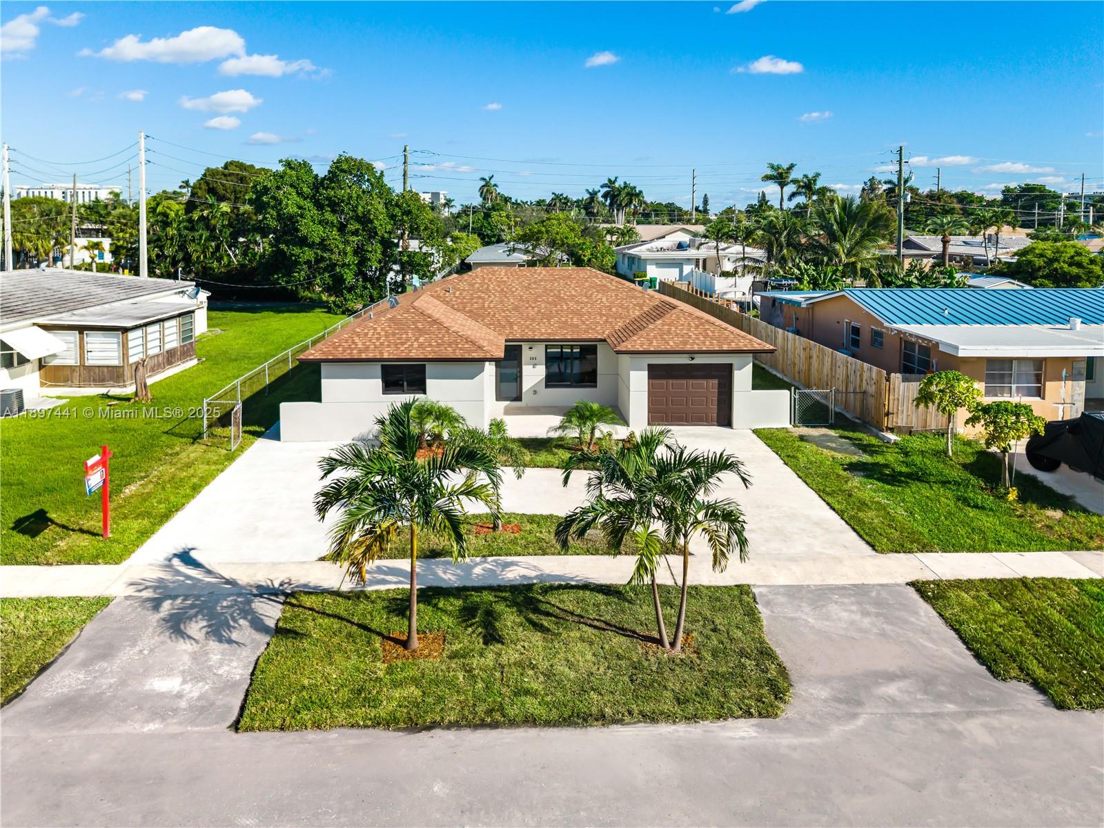 Rebuilt from the ground up in 2025, this stunning home offers a spacious open-concept layout with one car garage, and elegant porcelain floors and modern finishes throughout. The kitchen features contemporary cabinetry, quartz countertops, and sleek design details. It includes 3 bedrooms and 2.5 bathrooms, beautifully updated with stylish bathrooms and premium fixtures. The circular driveway and landscaped front yard create a welcoming entrance, while the expansive backyard provides endless possibilities for outdoor living or entertainment. Central A/C, impact windows, and move-in ready condition. Conveniently located in the heart of Dania Beach, east of US-1 — just 5 minutes from the beach, airport, shopping, casinos, and a vibrant mix of dining and cultural attractions.