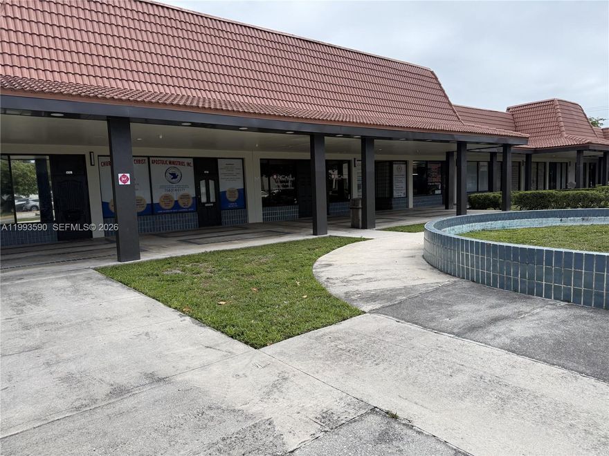 Conveniently located at the intersection of Inverrary Boulevard and 44th Street, this professional office space is anchored by Bank of America and surrounded by a diverse mix of established businesses. The unit is well-suited for both retail and professional use.

Upon entry, you are welcomed by a spacious reception and waiting area, featuring glass-enclosed access to a private conference room. The entire space is finished with elegant porcelain flooring, creating a clean and polished look throughout. Just behind the reception area is a dedicated network/data closet for added functionality.

Beyond reception, the office opens into a comfortable eight-cubicle workspace with additional room for flexible office configurations or workstations. To the left, you’ll find two large executive offices, each equipped with built-in desks and cabinetry.

Toward the rear of the unit, there is a restroom and kitchenette, along with access to a generously sized additional office area with a secondary rear entrance—ideal for operations requiring separate access or expanded workspace.