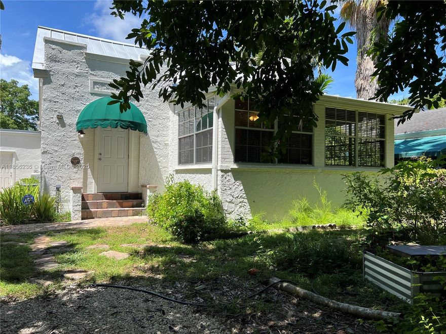 Price reduction for a quick sale! Beautiful updated historic home located in the Historic District of prestigious South Miami. Nestled in an area surrounded by native plants, birds, and butterflies, makes you feel in a tropical paradise all year round. Quiet one-way street by a canal leads to Brewer Park, a tropical Audubon Society birding location. Three bedrooms, two baths, formal living and dining area leading to a very spacious kitchen with an additional room. The spacious primary bedroom provides a serene retreat overlooking the lush backyard, with ample closet space and a private bathroom. A sunroom and loft offer additional space. Garage converted to utility room and  laundry with Brazilian racks. This home combines functionality and charm with a beautiful and peaceful environment.
