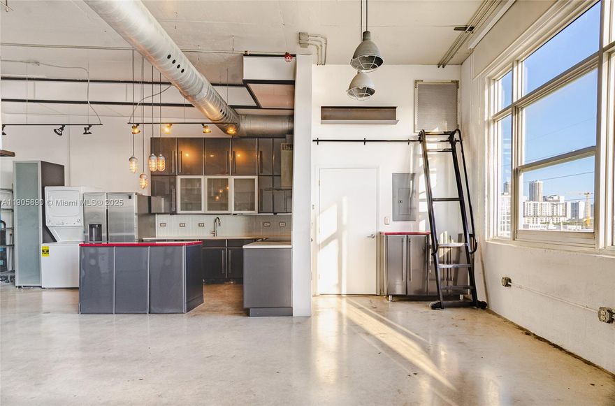 Live/work Modern industrial style open - concept Loft with exposed ductwork, metal beams, and polished concrete
floors that give the space an authentic urban edge and mezzanine level. Open floor plan and minimalist aesthetic. 
kitchen is equaled with stainless steel appliances located in Miami's Creative District 1,063 Sq. Ft.