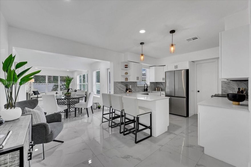 Spacious 3 bedroom, 2 bath residence offering 1,745 adjusted square feet of living space on a 6,500+ sq ft lot in desirable Wilton Manors. This home features a generous floor plan, open kitchen concept with stainless steel appliances, highlighted by a large primary suite with a walk-in closet and dual-vanity bathroom, porcelain tile flooring, laundry room with side by side full size washer and dryer, while the property also offers ample parking. The expansive backyard provides excellent space for outdoor enjoyment and entertaining. Conveniently located near Wilton Manors dining, shopping, parks, and just a short drive to the beaches.