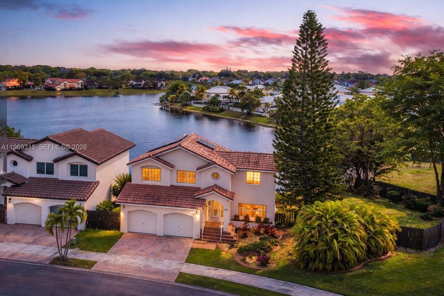 MASSIVE TWO-STORY LAKE HOUSE WITH THE BEST LAKE VIEW IN ALL THE DEVELOPMENT. Sitting on an spacious 8,624sq ft lot, it features the second-largest lot on the lake. With unobstructed views, its perfectly positioned to capture the stunning full moon reflection on the water from the master suite balcony while feeling the lake breeze. Inside, enjoy a spacious floor plan with 4 bedrooms, a screened terrace, a master suite balcony, impact windows/doors, a renovated kitchen, two-car garage, and Paid-off solar panels that will power the house. FEATURES: Perimeter fence (2022) Paid-off solar panels with charging power cell(2021) New washer & dryer, 5-ton AC unit (2009) Remodeled kitchen Screened patio Master suite balcony Full alarm system. This Is Waterfront Living