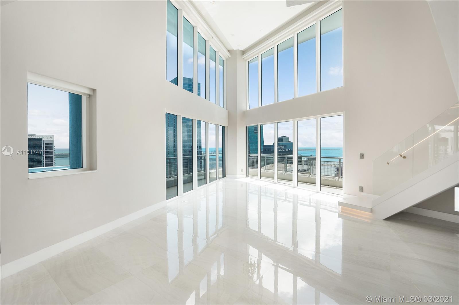 This stunning and visually dramatic 2 story residence at Infinity at Brickell is a one of a kind unit. Floating 42 floors up on the south east corner with expansive views of the Bay/ Ocean and the city. This unit will wow you from the very entrance with the double height ceilings and floor to ceiling glass windows that make you feel like you are in the clouds. Recently renovated and Inspired by Modern Italian design. Features include a custom floating staircase illuminated by LED lights, textured surfaces, wallpaper, entire marble slab backsplash in kitchen, and electronic shades. Building has resort style amenities and is extremely well located. Enjoy walking to everything Brickell has to offer. Easy to show call LA.