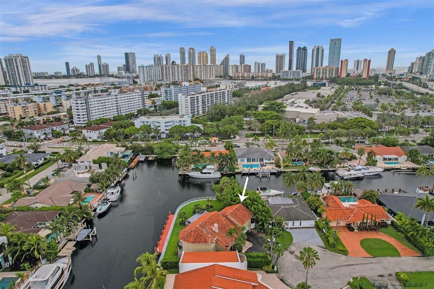 This incredible home is on private cul-de-sac street in a gated community on the water in desirable Eastern Shores. The home is completely renovated & furnished with Marble & wood floors throughout. Master level is in between the first & second story in it's own private wing with balcony overlooking pool, spa & the intercoastal. All bedrooms have own private bathroom with wraparound balcony. Huge kitchen with breakfast counter, stainless steel appliances, wine cooler & gas stove. Backyard is great for outdoor entertainment with heated pool, spa and plenty of room for outdoor activities, including a 65 foot boat dock that can dock a large boat or yacht. The sea wall is 180 feet long all around. NO HOA & just few minutes to beach & Oleta State Park. Short term rentals allowed 3 times yearly