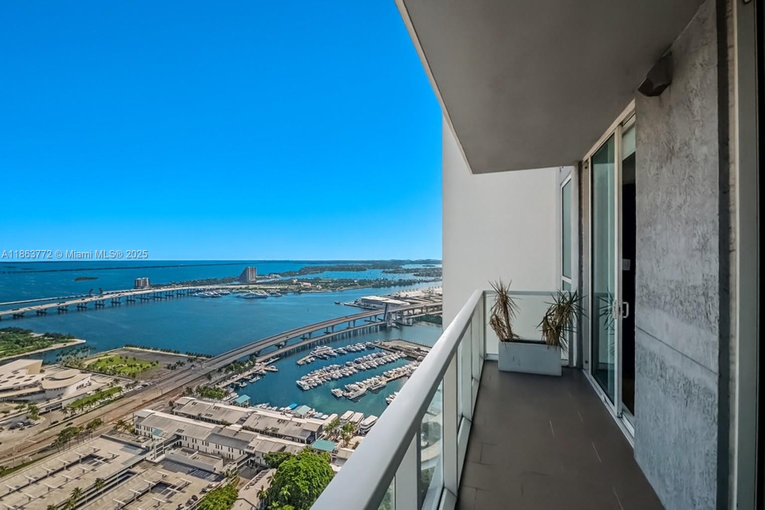 Experience elevated living in this fully furnished two-bedroom, two-bathroom residence, perched on the exclusive 47th floor. Spanning 1,293 square feet, the home is thoughtfully curated with designer furnishings and custom millwork that infuse elegance and sophistication throughout. Floor-to-ceiling windows frame sweeping panoramic views of Miami’s skyline and beyond, while natural light fills every corner. The open-concept design seamlessly unites the living, dining, and kitchen areas—perfect for both effortless entertaining and everyday comfort.