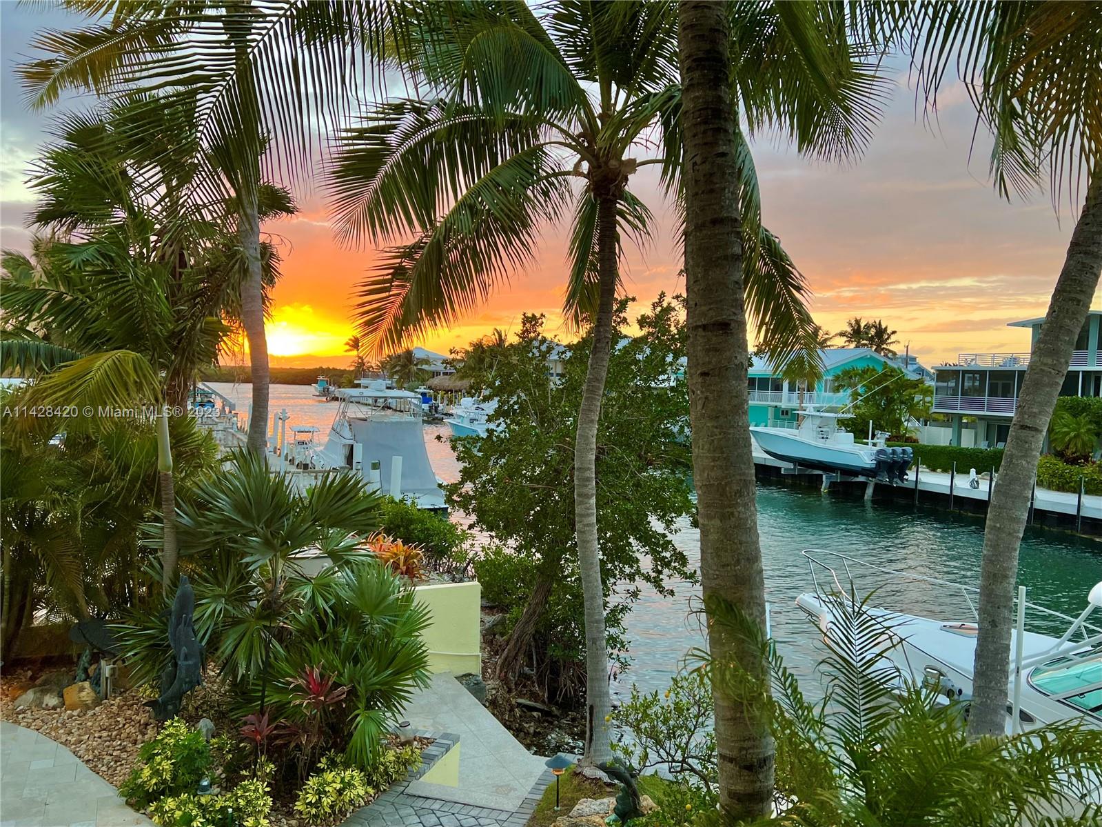 Impressive estate home in desirable Venetian Shores, Islamorada! Featuring 6 bedrooms and 3 baths, with marble floors throughout, this home has three levels of living space. The entrance foyer opens to three bedrooms on the first level, with two separate living areas. The second floor of the home is the primary living area, with soaring ceilings that open to the third floor, open grand living room, fireplace, kitchen and two bedrooms. The main bedroom suite encompasses the third floor and has a large open bedroom, spacious marble bath and a loft sitting area overlooking the living room. An emphasis on outdoor living shows in the pool with hot tub, large open bar with wine fridge, wired television and music while relaxing poolside. Two boat lifts provide dockage for your boats