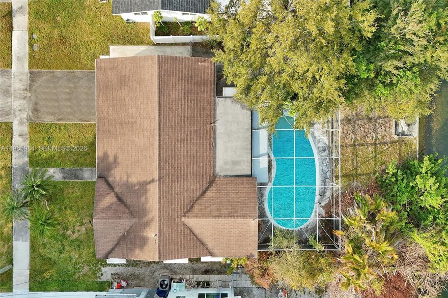 Charming CANAL-FRONT home in Central Hollywood / Hollywood Heights, featuring a screened POOL (screen needs repair) and an oversized backyard with breathtaking canal views, perfect for entertaining or adding a private dock like neighboring homes. This 3-bedroom, 2-bathroom residence sits on a 13,528 sf lot offering ample outdoor space. It features a spacious living area, dining space, and a closed family room ideal for gatherings. Enjoy a classic Japanese-style kitchen in excellent condition and highly sought-after TERRAZZO & tile floors throughout. The home includes a GARAGE plus two additional parking spaces. Enjoy nearby amenities including: the YMCA gym, TY Park, the famous HOLLYWOOD BEACH, and the Hard Rock area, within the Hollywood Hills Elementary zone, and near private schools such as Nativity Catholic and Chaminade-Madonna Prep. Close to Memorial Hospital, shopping, and quick access to I-95, all in a quiet, low-traffic neighborhood. Sold As-Is at an exceptional price due to an estate sale. A rare canal-front opportunity with tremendous potential!