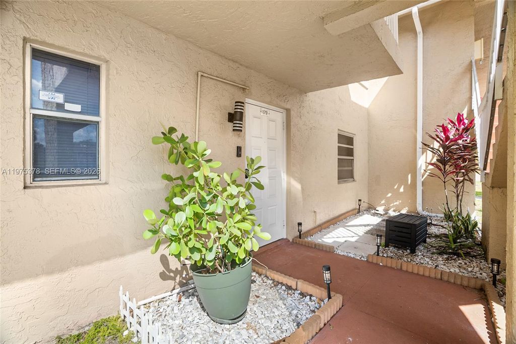 Photo of 879 Twin Lakes Dr #1-B, Coral Springs, FL 33071 (MLS # A11975378)
