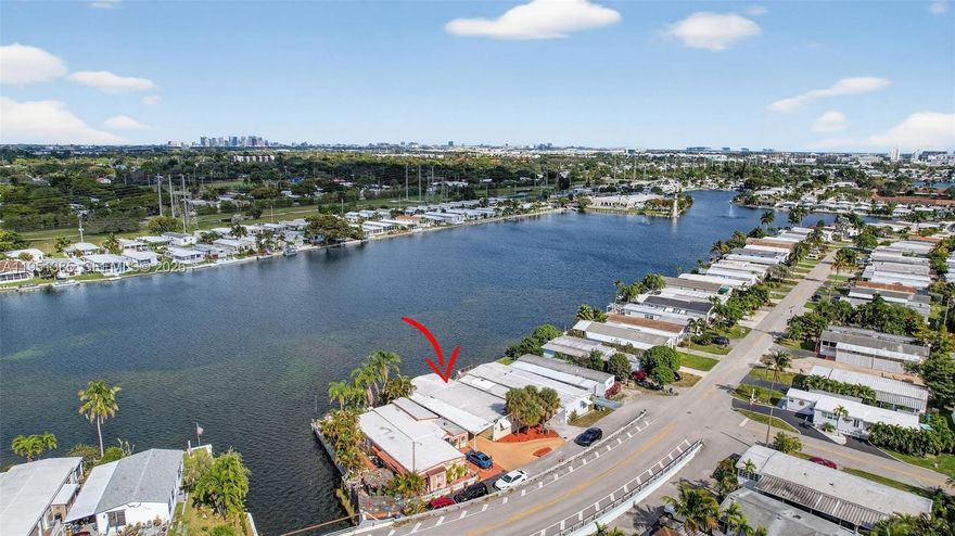 True waterfront living in the heart of Fort Lauderdale/Dania Beach. Set directly on the lake within the sought-after Estates of Fort Lauderdale, 3033 Lakeshore Drive offers an exceptional blend of location, space, and serene views rarely found so close to the city’s best dining, shopping, beaches, and major roadways. This spacious 3-bedroom, 3-bath Double Wide features an open floor plan with generously sized living and dining areas designed for both comfortable everyday living and effortless entertaining. Natural light fills the home, enhancing the flow and connection between spaces. The kitchen is equipped with stainless steel appliances, abundant cabinetry, and ample counter space, opening seamlessly to the main living areas. Large bedrooms provide flexibility for guests, a home office, or multigenerational living, while extensive storage throughout the home adds a level of convenience not often found at this price point. Step outside to a large waterfront deck, where peaceful lake views and cooling breezes create the perfect setting for relaxing, entertaining, or enjoying sunrise and sunset moments. A 1-car carport and additional storage complete the property. The Estates of Fort Lauderdale is a well-established waterfront community offering a quiet residential atmosphere Just minutes from Seminole Hard Rock Hotel & Casino, downtown Fort Lauderdale, and the beautiful coastline.A rare opportunity to enjoy waterfront living, space, and central Fort Lauderdale convenience in one remarkable home.
