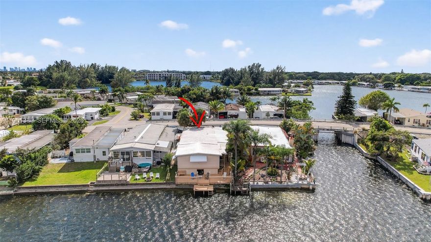 True waterfront living in the heart of Fort Lauderdale/Dania Beach. Set directly on the lake within the sought-after Estates of Fort Lauderdale, 3033 Lakeshore Drive offers an exceptional blend of location, space, and serene views rarely found so close to the city’s best dining, shopping, beaches, and major roadways. This spacious 3-bedroom, 3-bath Double Wide features an open floor plan with generously sized living and dining areas designed for both comfortable everyday living and effortless entertaining. Natural light fills the home, enhancing the flow and connection between spaces. The kitchen is equipped with stainless steel appliances, abundant cabinetry, and ample counter space, opening seamlessly to the main living areas. Large bedrooms provide flexibility for guests, a home office, or multigenerational living, while extensive storage throughout the home adds a level of convenience not often found at this price point. Step outside to a large waterfront deck, where peaceful lake views and cooling breezes create the perfect setting for relaxing, entertaining, or enjoying sunrise and sunset moments. A 1-car carport and additional storage complete the property. The Estates of Fort Lauderdale is a well-established waterfront community offering a quiet residential atmosphere just minutes from downtown Fort Lauderdale and the coastline. A rare opportunity to enjoy waterfront living, space, and central Fort Lauderdale convenience in one remarkable home.