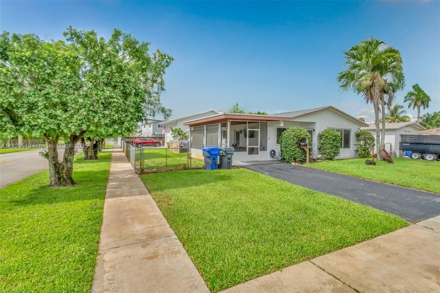 Charming 3-bedroom, 2-bath one-story home on a desirable corner lot. This well-maintained property features new impact windows and a new roof, a screened-in front porch, private driveway, and a large detached garage with its own full bathroom—ideal for a workshop, guest suite, or additional storage. The home offers bright living spaces with a large picture window and attractive landscaping. Conveniently located near shops, dining, and just a short drive to Hollywood Beach!